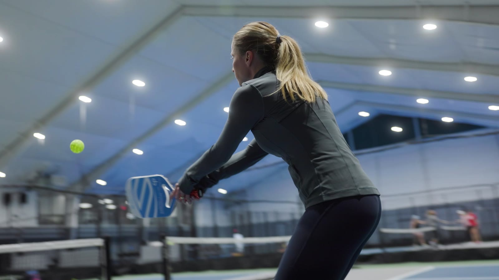 Player training with a Rallie ball machine on an indoor court