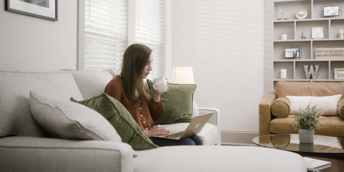 Woman relaxing at home with a laptop