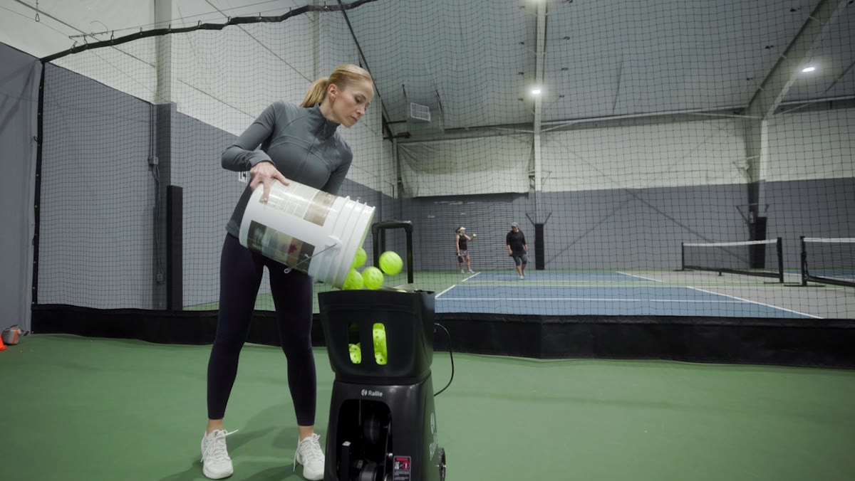 Player hitting on an indoor pickleball court